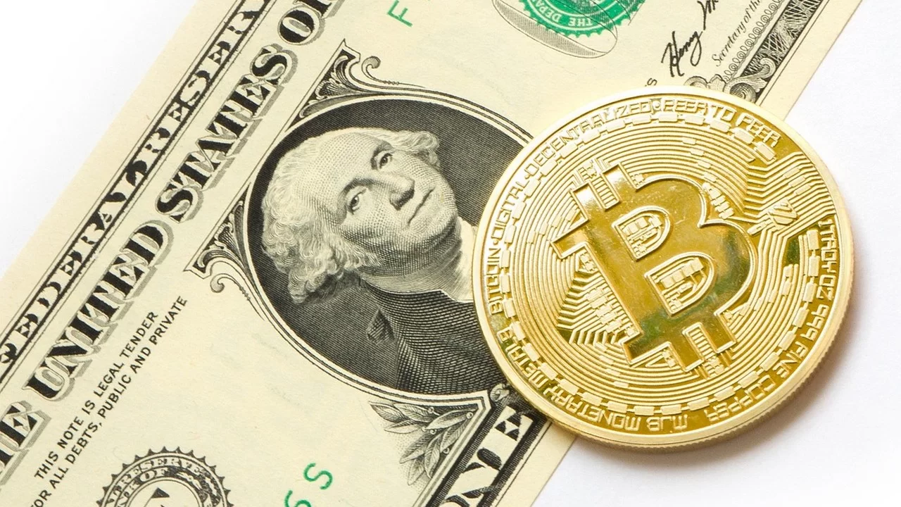 Nota de um dólar e um Bitcoin