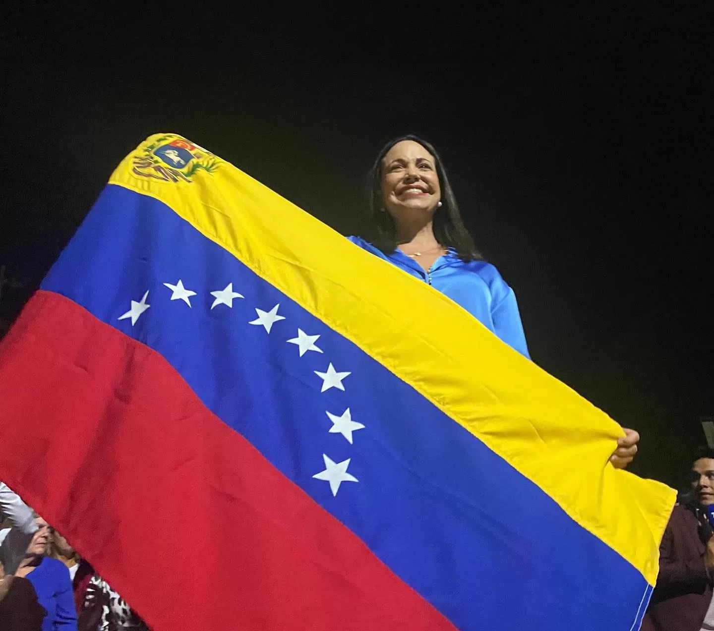 María Corina Machado segura bandeira do seu país